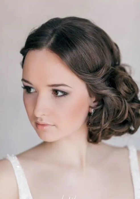 a super elegant curly side updo with a volume on top is a chic hairstyle that wows