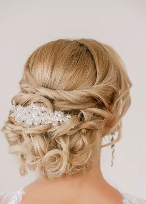 a twisted and curled updo with a rhinestone headpiece is a chic idea for a refined wedding