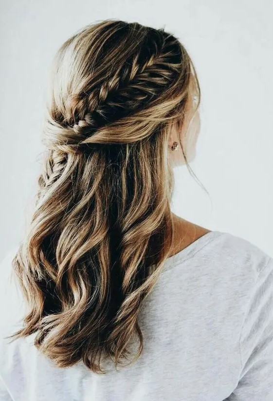 a boho chic wedding half updo with twists and a large French braid is a timeless boho chic option for any season