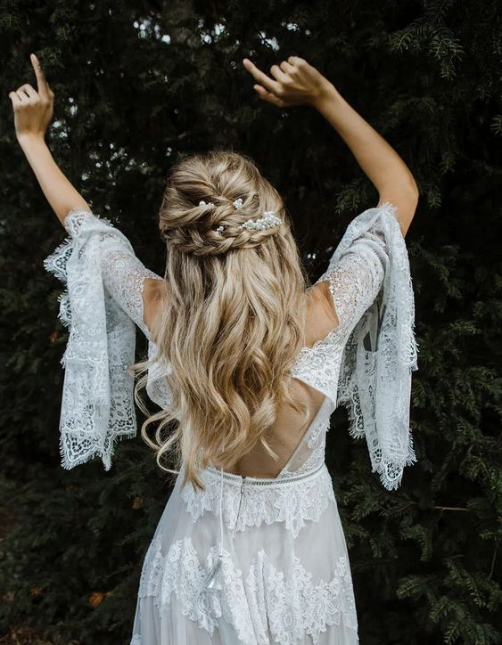 a boho half updo with twists and a braided halo, with waves down is a lovely idea for a summer wedding