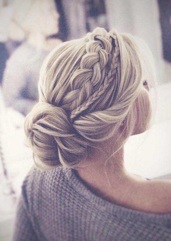 a catchy rustic wedding hairstyle with a low bun, a twisted and double braid halo and some locks down is cool