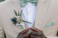 10 a tan suit, a white shirt and a sage green bow tie and handkerchief for a chic groom’s look