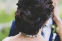 11 elegant curled wedding updo with a volume and with some highlights to show off the locks and the volume