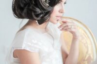 12 a voluminous curly side updo with some locks down and a statement embellished floral hairpiece that rocks