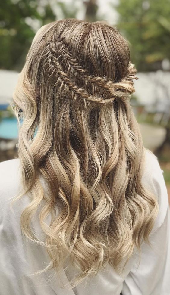 a boho wedding half updo with a double fishtail braid halo and waves down is a dreamy and beautiful idea