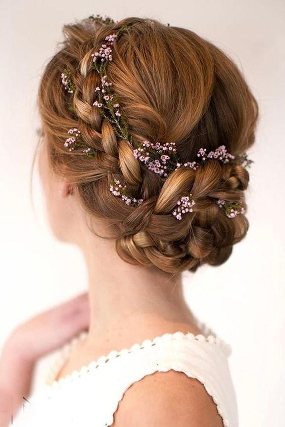 a cool ginger braided updo with a catchy top, a braided halow and some fresh blooms tucked in is a lovely idea for a boho bride