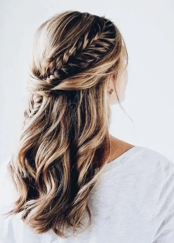 A twisted and braided half updo with messy beachy waves for a boho or free spirited bride