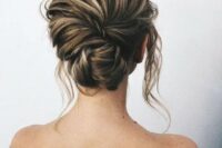 17 a chic textural messy low chignon with a twist and locks down looks elegant