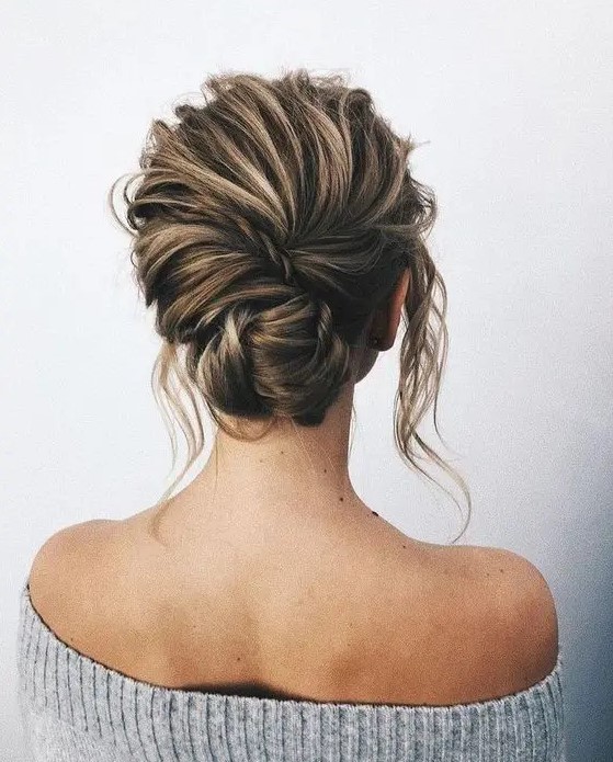 a chic textural messy low chignon with a twist and locks down looks elegant