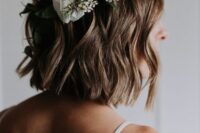 17 a light brunette wavy long bob accented with white blooms and greenery is a very relaxed wedding hairstyle to try