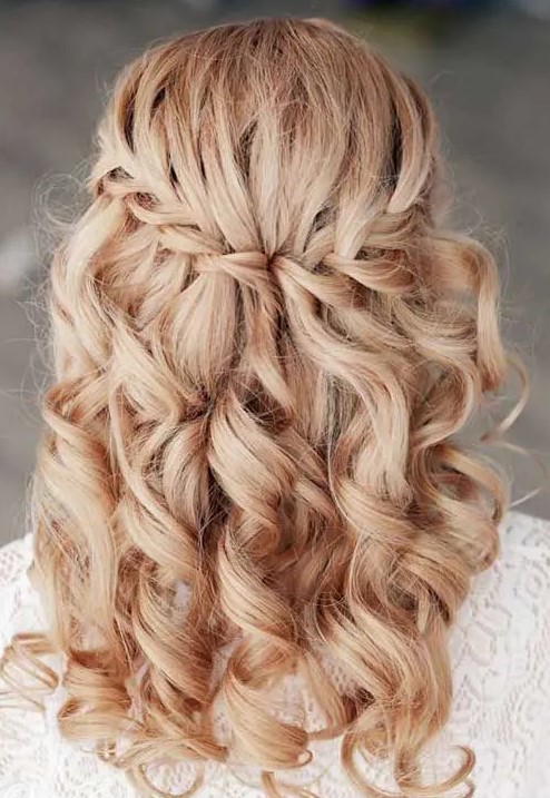 a braided half updo with curls looks cute, girlish and very glam, it will fit most of bridal styles
