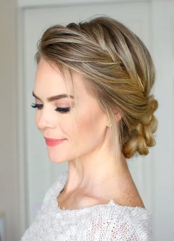 a fishtail braided halo plus a braided low bun and some hair down is a chic and comfy to wear hairstyle