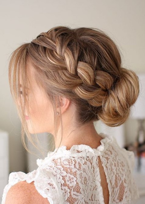 a French braid side halo plus  low bun with some locks down look voluminous and very romantic