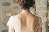 23 a messy curly wedding updo is a natural and chic choice and some locks down will create a movement effect instantly