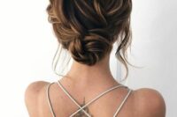24 a lovely twisted wedding low bun with a braided twisted top and some locks framing the face is a chic and cool idea