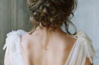 24 a messy curly wedding updo with a gold and rhinestone hair vine is a lovely idea for an effortlessly chic bride
