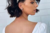 24 a short wavy bob with a pearl and rhinestone hairpiece is a refined and bold idea for a modern chic look