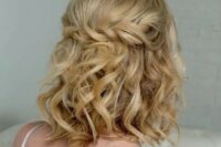 25 a curly half updo with a twisted braid and curls down plus a peachy crystal crown are a cool combo