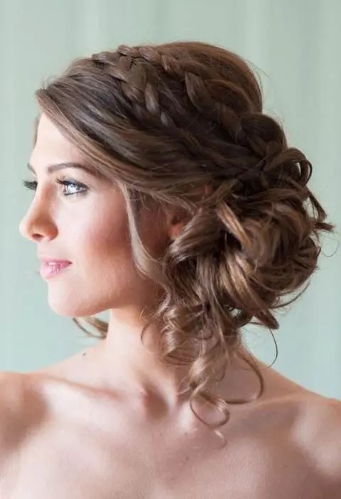 A low side wavy and braided updo with a double braided halo is a trendy idea with a boho rustic touch