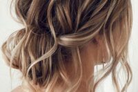 26 a messy wavy low bun with a messy wavy top and some locks down is a cool and lovely idea for a wedding, it looks effortlessly chic