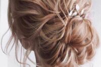 27 a messy wavy low bun with a wavy top, a braided touch, a low bun and a leaf hair piece is amazing