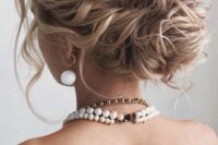31 a beautiful and messy wavy wedding low bun with a wavy top, some locks down is a gorgeous idea for long hair