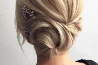 31 a side twisted low bun with some locks down and a rhinestone hairpiece on one side