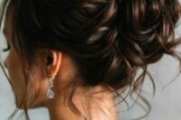 32 an elegant wavy wedding updo with a wavy top and a wavy bun, with some locks down is a chic and cool idea to rock