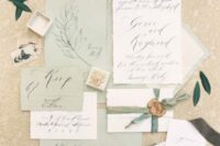 33 a romantic sage green wedding invitation suite with calligraphy and some botanical detailing