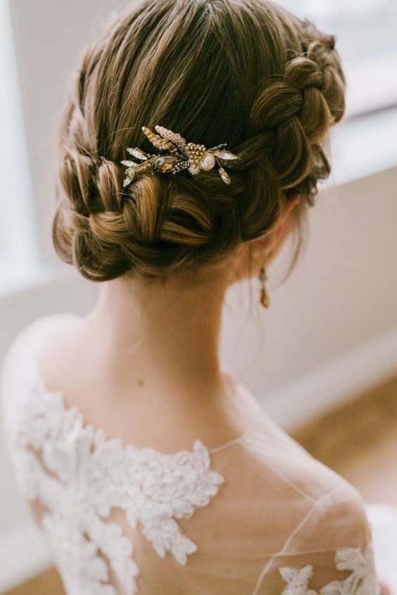 a stylish braided updo with a halow, a sleek top and a small braded and pearl hair piece is a stylish idea for most of bridal styles