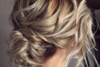 35 a wavy low bun with a wavy top and some locks down, with a wavy bun is a cool idea that is effortlessly chic and elegant