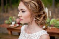 36 a stylish messy twisted low bun with a messy textural top and somw waves down is a cool idea of a wedding hairstyle