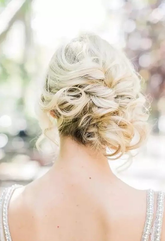a curly side updo with some locks down for a elegant and effortless feel is a very chic and stylish beach and not only beach wedding idea