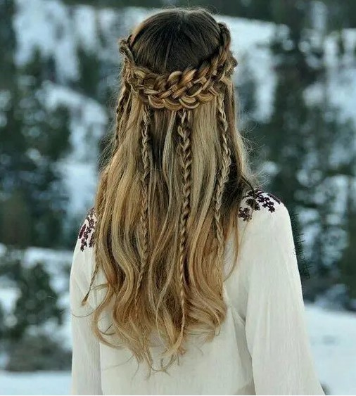 A viking inspired wedding hairstyle, a half updo with a double braided halo and some braids hanging down