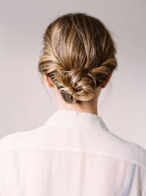 A twisted low bun with a textural top is long lasting lob styling for a bride or bridesmaid
