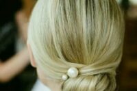 39 a twisted low bun with pearl pins and a sleek top for a modern take on a traditional look