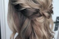 40 a medium half updo with blonde balayage, a braided halo and a bump and waves down is a timeless solution