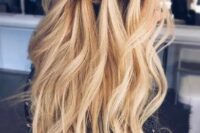 42 a long wavy half updo hairstyle with a braided halo and locks down for a boho feel
