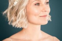 42 a lovely soft blonde wavy bob with a fresh flower headband is a cool and lovely solution for a wedding