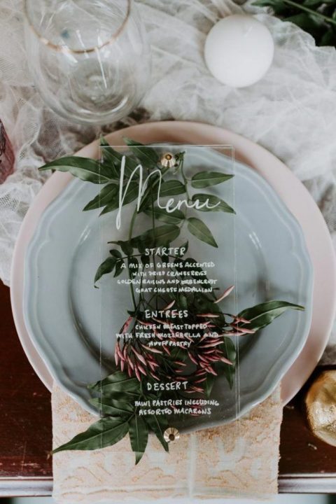 an elegant chic sage green plate, greenery and pink blooms plus an acrylic menu for an airy spring wedding