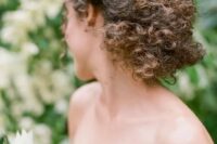 43 a braided low updo with natural curls is a chic textural idea that will make a statement in your look