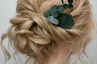 43 a breezy twisted low updo with a messy twisted top and some waves down plus a touch of fresh eucalyptus