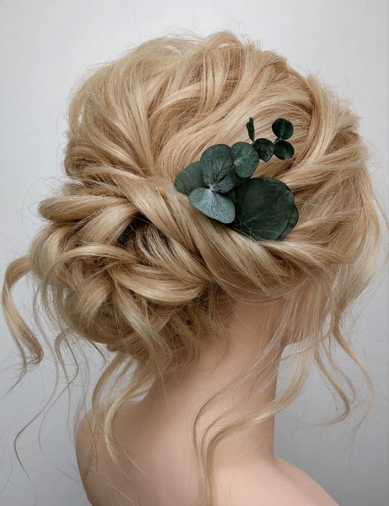 a breezy twisted low updo with a messy twisted top and some waves down plus a touch of fresh eucalyptus
