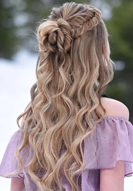 a lovely boho wedding hairstyle with a fishtail braid halo, a large knot and waves down is amazing