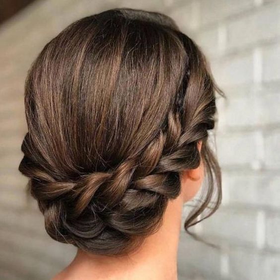 a braided updo with a halo, some locks down and a sleek top is a stylish idea for many bridal styles