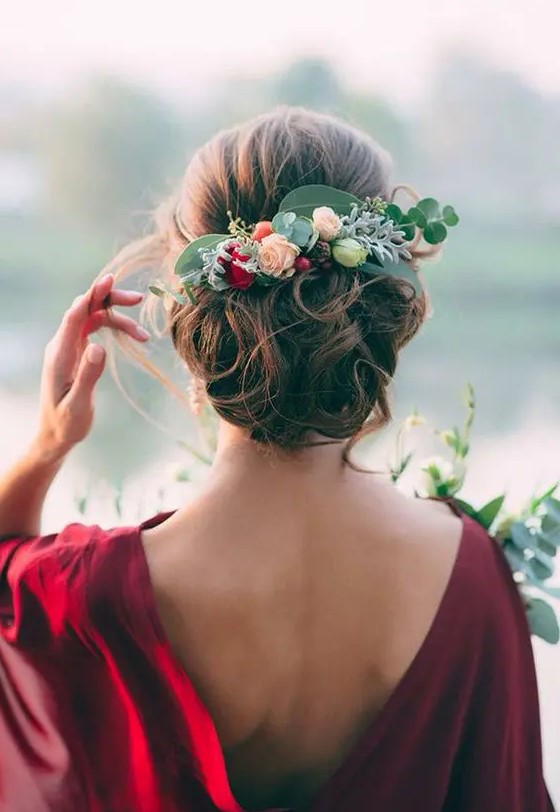 a curly wedding updo topped with a fresh flower and greenery headpiece is a fantastic idea for the fall
