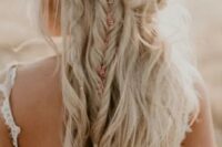46 a messy boho wedding half updo with multiple twists, braids and waves and with some blooms tucked into the hair