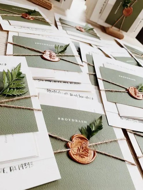 woodland wedding invitation suite with white and sage green cards, twine, seals and fern is ultimate