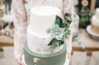 48 a chic modern green and white wedding cake with a marble tier, greenery and succculents, gold leaf and a calligraphy topper