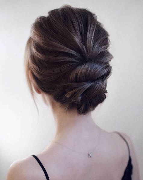 a chic wedding updo with a dimensional bump and twists will keep you picture-perfect during the whole day